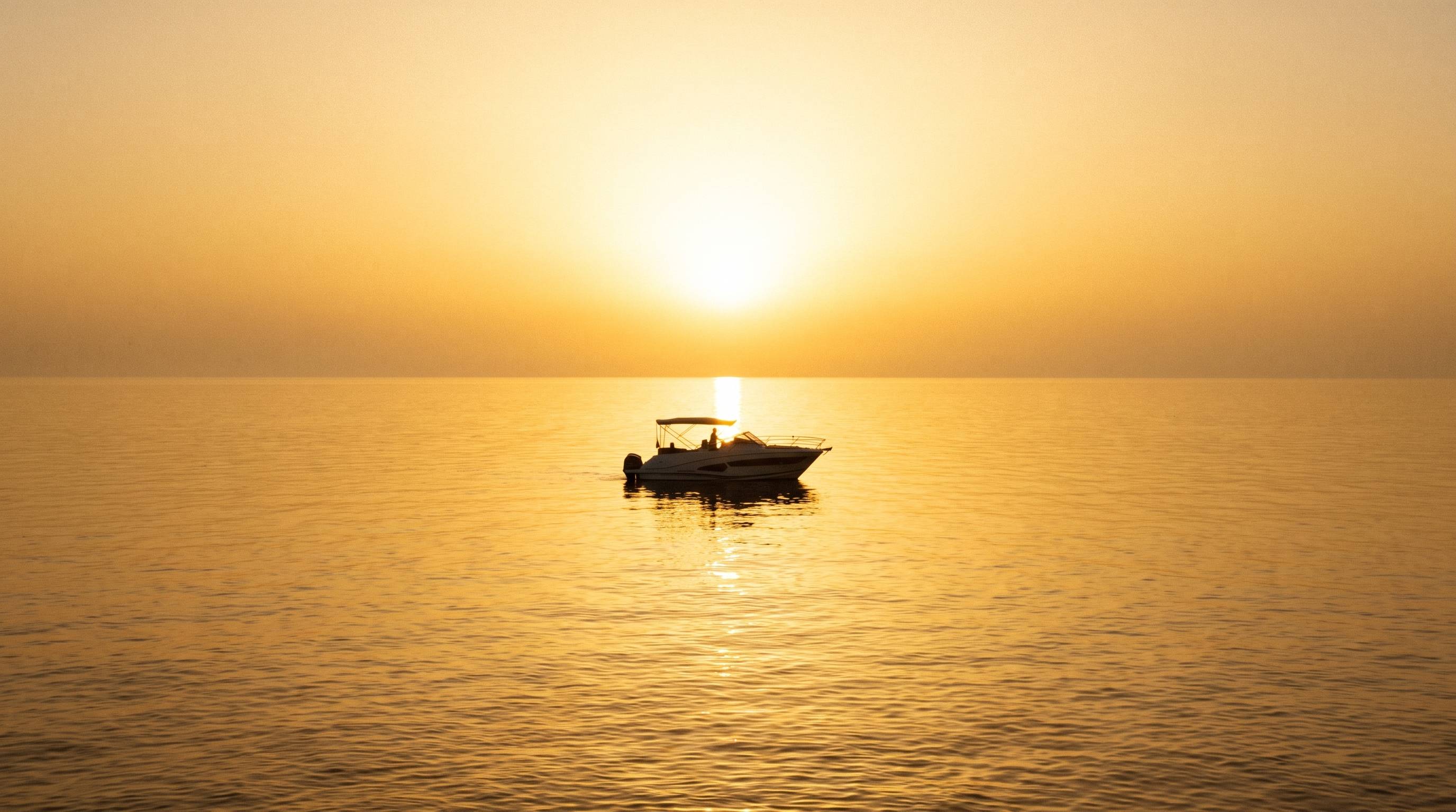Red Wharf Bay on a golden sea at sunset